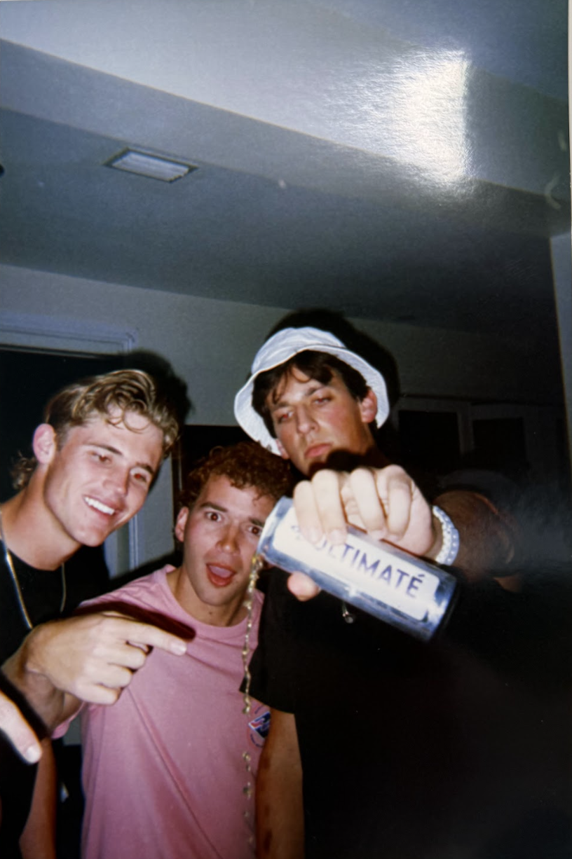 Friends pouring an ULTIMATÉ can at a house party